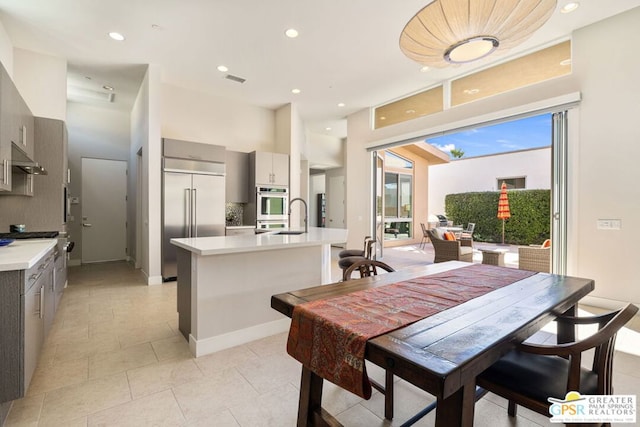 dining area with sink and light tile patterned floors