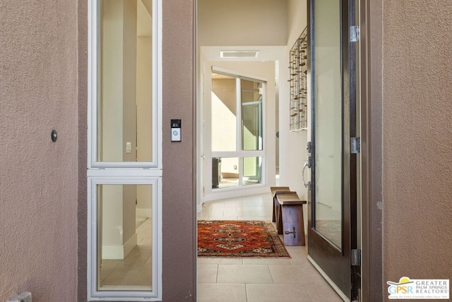 hallway with light tile patterned floors