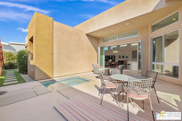 view of swimming pool with a jacuzzi and a patio area