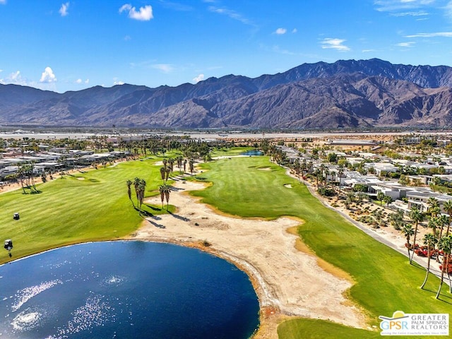 surrounding community with a water and mountain view