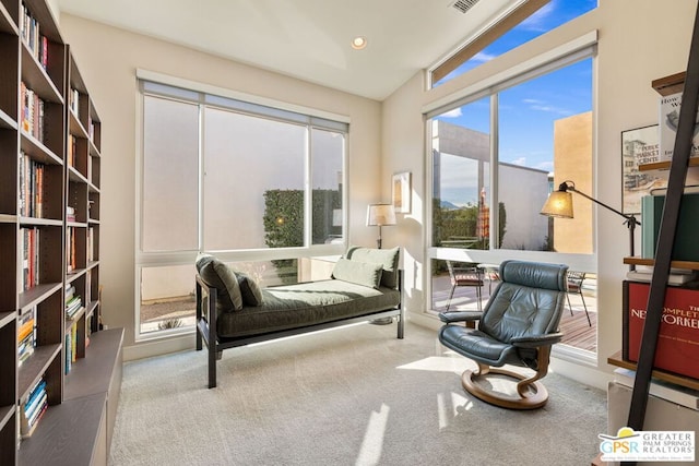 living area with light colored carpet