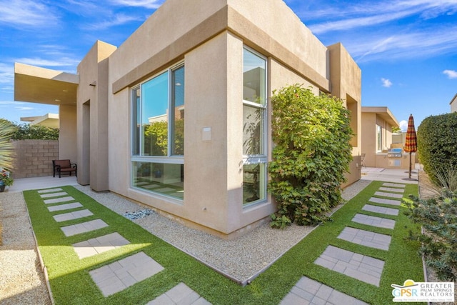 view of side of property with a patio area