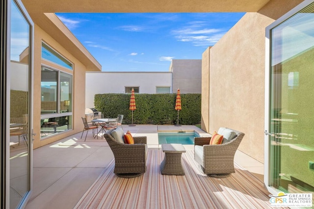 balcony with an outdoor hangout area and a patio area