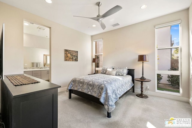 carpeted bedroom with connected bathroom and ceiling fan