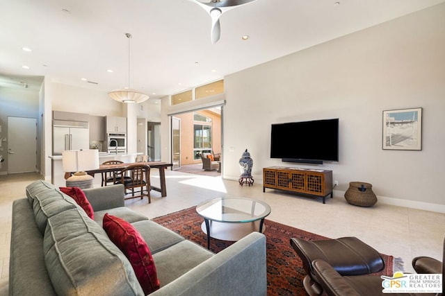 tiled living room featuring a towering ceiling