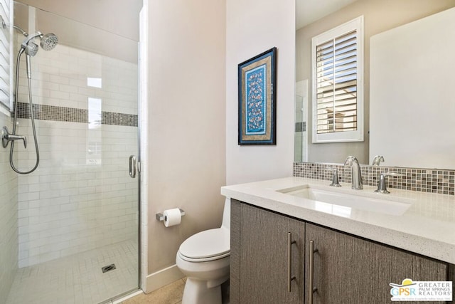 bathroom with vanity, walk in shower, and toilet