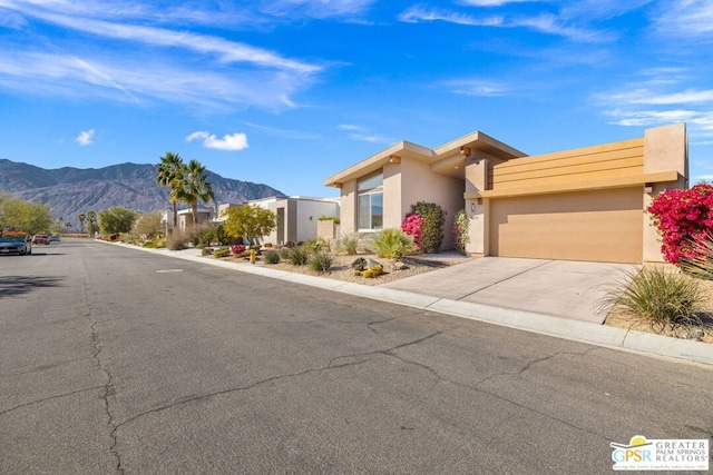 view of front of home featuring a mountain view and a garage