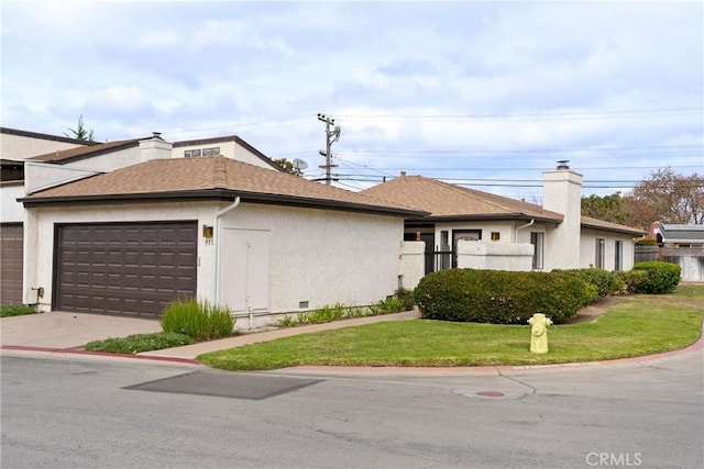 ranch-style house featuring a garage and a front yard