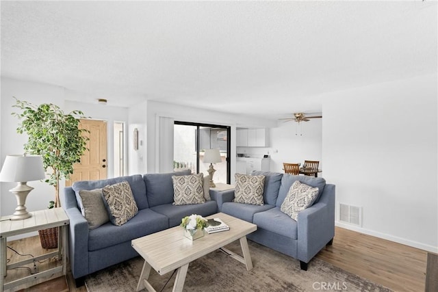 living room featuring washer / dryer and hardwood / wood-style floors