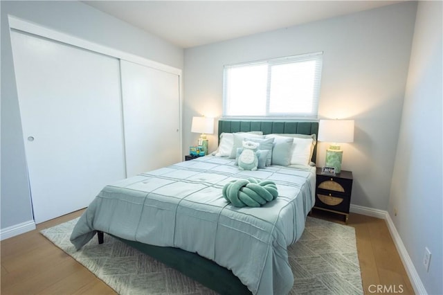 bedroom featuring hardwood / wood-style floors and a closet