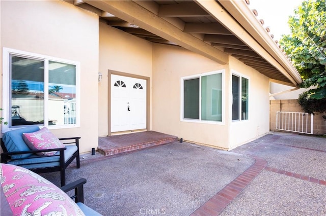 view of exterior entry featuring a patio area