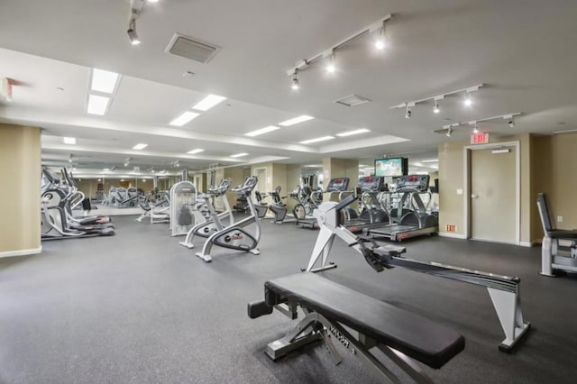 workout area featuring track lighting