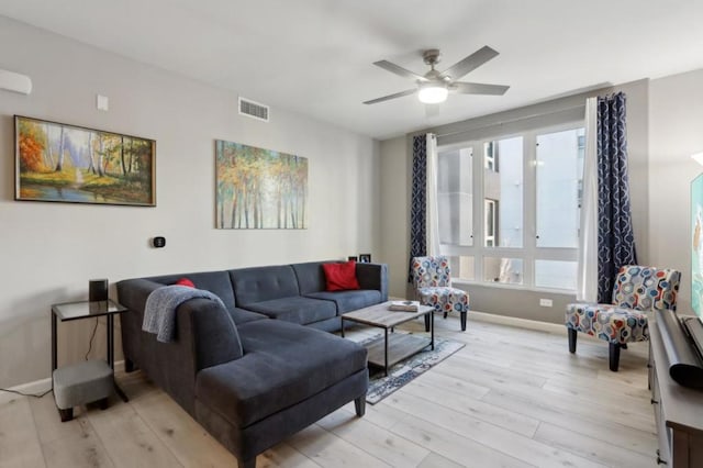 living room with ceiling fan and light wood-type flooring