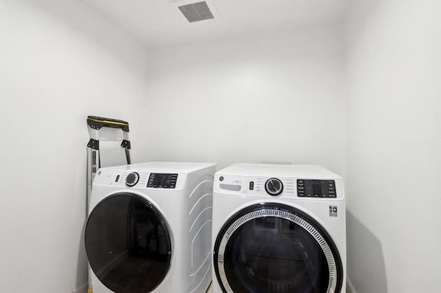 washroom featuring washing machine and dryer