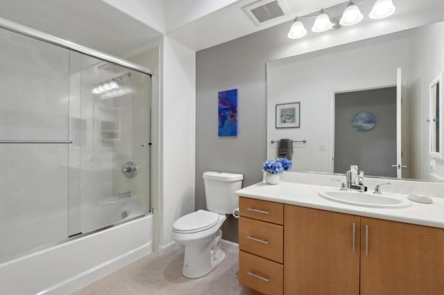 full bathroom featuring vanity, combined bath / shower with glass door, tile patterned floors, and toilet