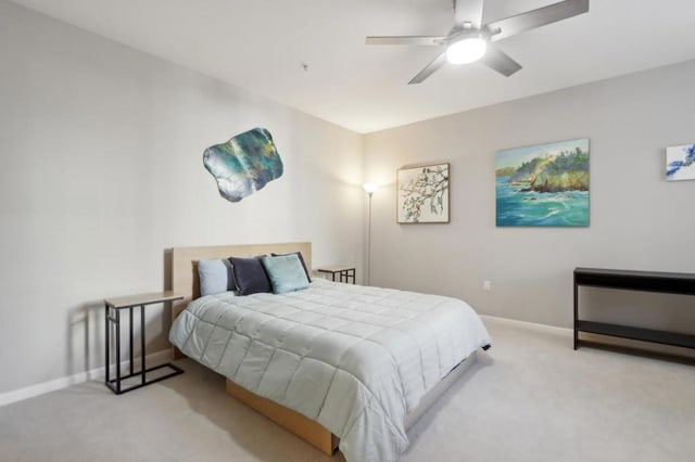 bedroom with light carpet and ceiling fan