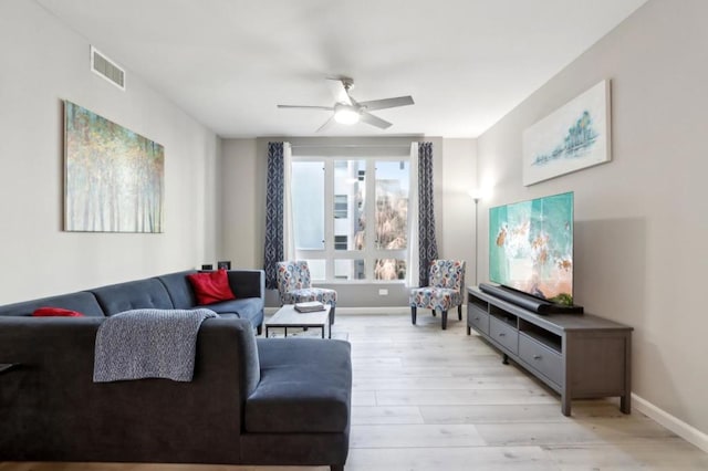 living room featuring ceiling fan and light wood-type flooring