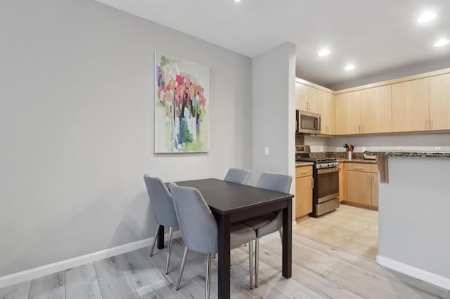 dining area with light hardwood / wood-style floors