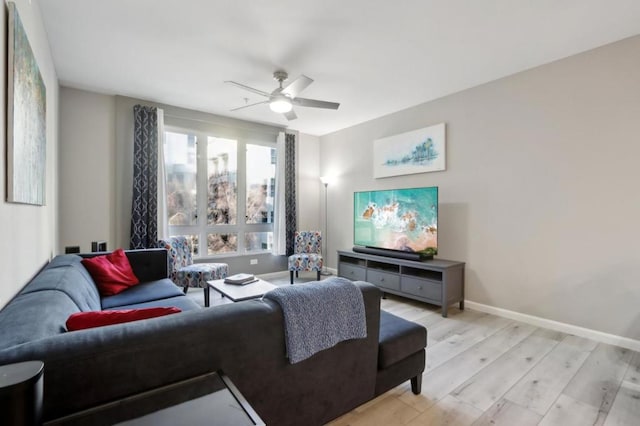 living room featuring ceiling fan and light wood-type flooring