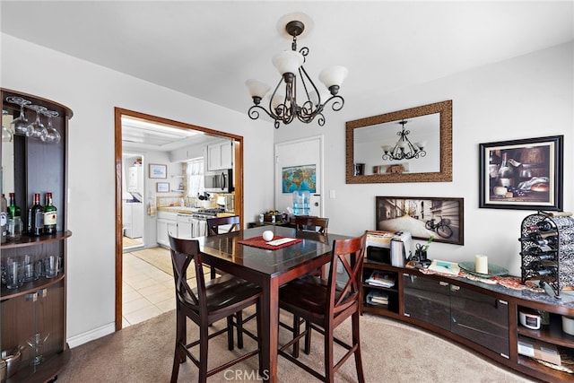 dining space featuring light tile patterned flooring and a chandelier