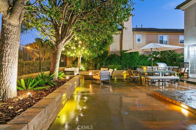 view of patio with fence, grilling area, and an outdoor living space