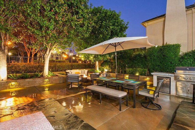 view of patio with an outdoor kitchen, outdoor lounge area, fence, grilling area, and outdoor dining space