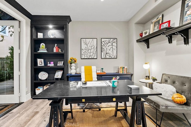 home office with hardwood / wood-style flooring