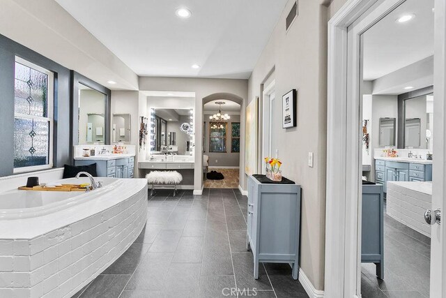 bathroom with a chandelier, recessed lighting, vanity, baseboards, and visible vents