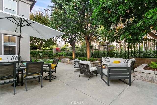 view of patio featuring outdoor dining area, outdoor lounge area, and a fenced backyard