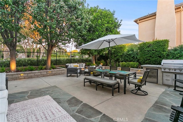 view of patio with outdoor lounge area, an outdoor kitchen, and grilling area