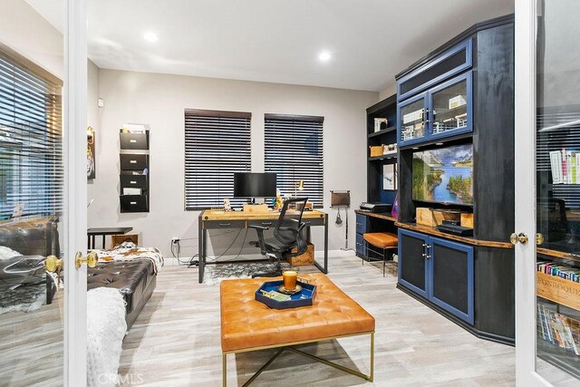 office with light wood-style floors and recessed lighting