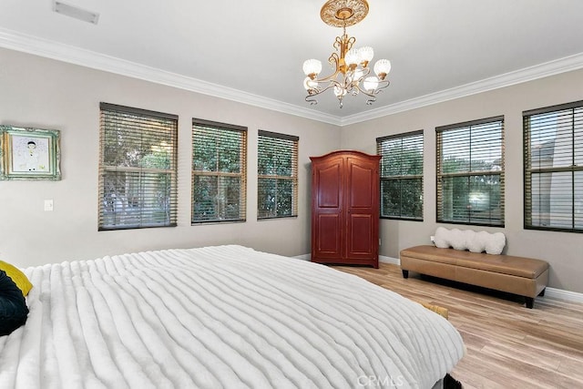 bedroom featuring an inviting chandelier, ornamental molding, and light hardwood / wood-style floors