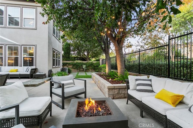 view of patio / terrace featuring an outdoor living space with a fire pit