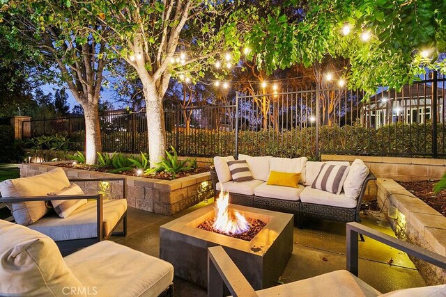 view of patio featuring an outdoor living space with a fire pit and a fenced backyard