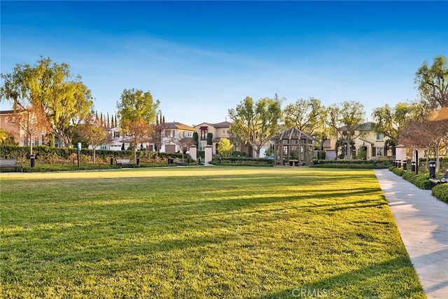 view of property's community featuring a residential view and a yard