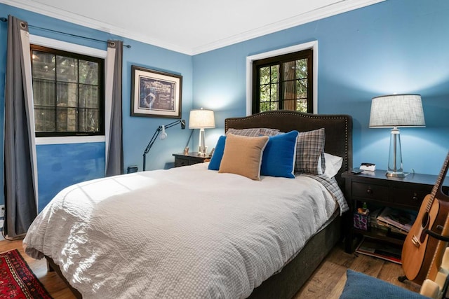 bedroom featuring ornamental molding and wood-type flooring