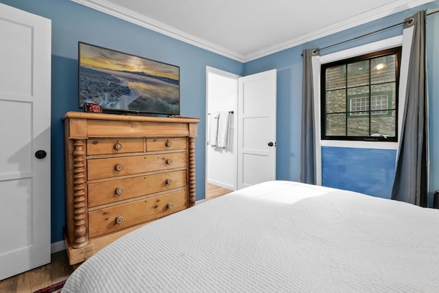 bedroom with wood-type flooring and ornamental molding