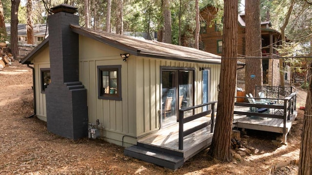 view of property exterior featuring a wooden deck