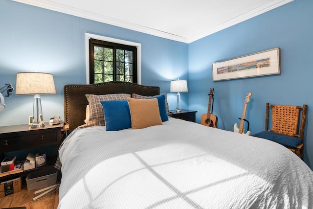 bedroom with crown molding and hardwood / wood-style flooring