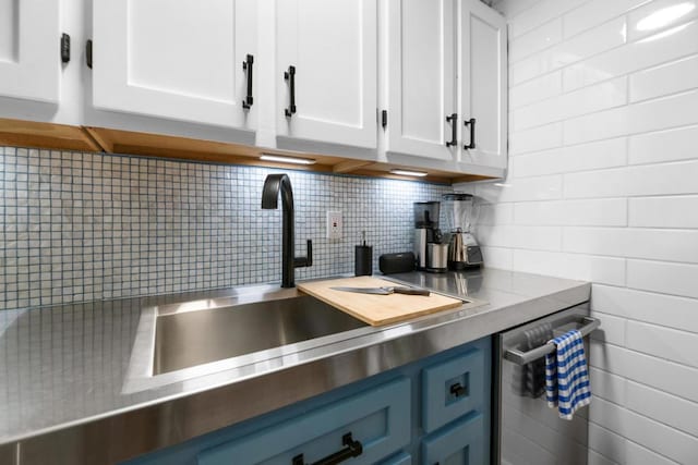 kitchen featuring sink, dishwasher, white cabinetry, tasteful backsplash, and blue cabinets