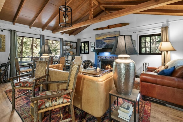 living room with lofted ceiling with beams, wooden ceiling, and light wood-type flooring