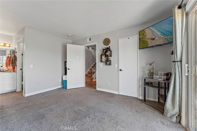 carpeted bedroom with visible vents and baseboards