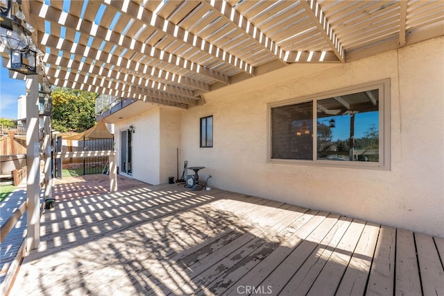 wooden deck featuring fence and a pergola