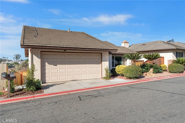 ranch-style home with a garage, fence, a tile roof, driveway, and stucco siding