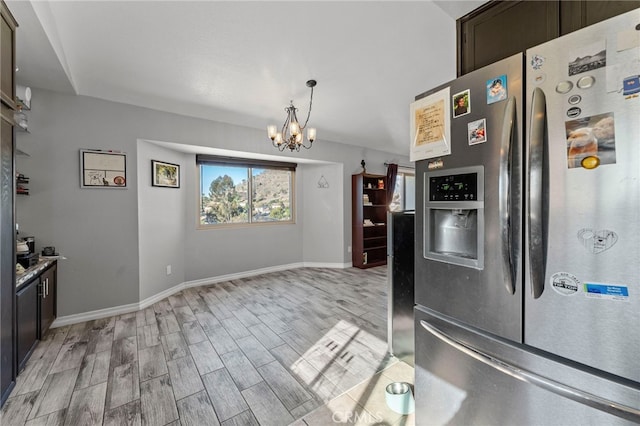 kitchen featuring light wood finished floors, baseboards, an inviting chandelier, and stainless steel fridge with ice dispenser