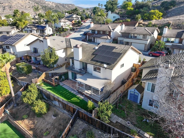 drone / aerial view featuring a residential view and a mountain view