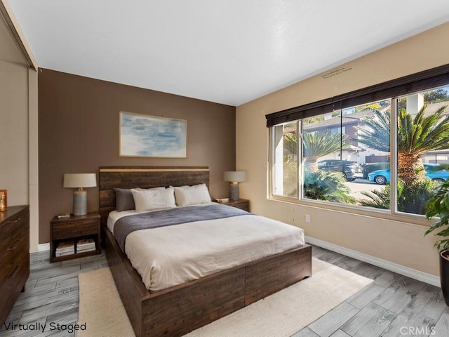 bedroom featuring light wood-style flooring and baseboards