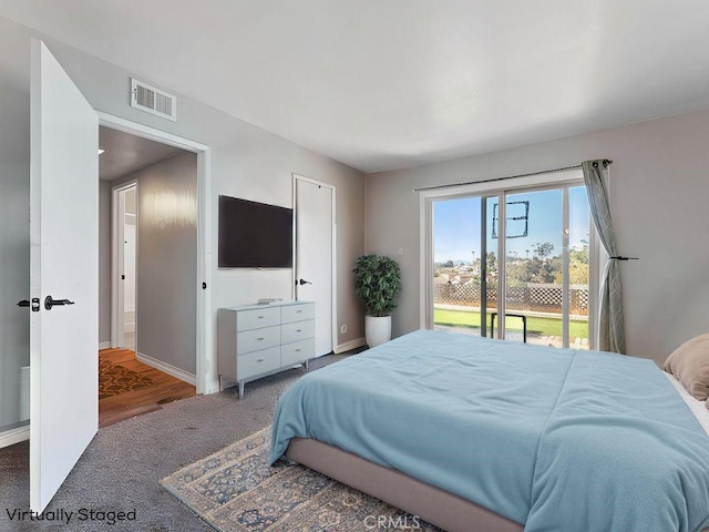 bedroom featuring access to exterior, visible vents, carpet floors, and baseboards