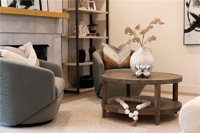 sitting room with a premium fireplace and wood-type flooring