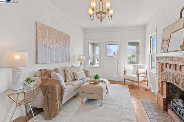 sitting room with crown molding, hardwood / wood-style floors, and a notable chandelier